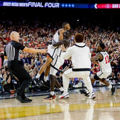 San Diego State’s Lamont Butler is embraced by teammate Aguek Arop after hitting the winning shot at the buzzer against Florida Atlantic in the semifinals of the NCAA Tournament at NRG Stadium on Saturday in Houston.  (Tribune News Service)