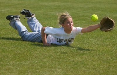 Alex Marquard, a senior at University High School, dives for a ball during softball practice. She has been recruited to play soccer at Western Washington University next year.
 (Kathryn Stevens / The Spokesman-Review)