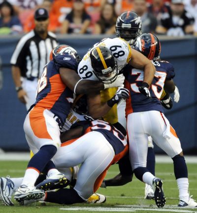 Broncos defenders bring down Pittsburgh’s Matt Spaeth (89). (Associated Press)