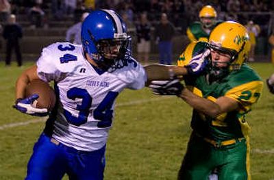 
Coeur d'Alene High's Justin Goodwin fends off Lakeland's Kyle Vandever in the second quarter Friday night at Lakeland High. Special to 
 (Bruce Twitchell Special to / The Spokesman-Review)