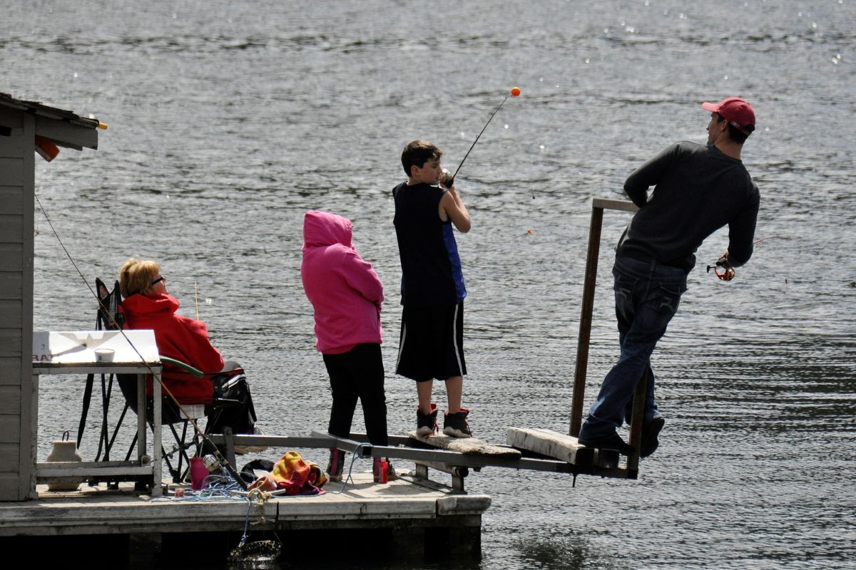 Opening day: All eyes are on Gabe Bradley as he tries to cast without hooking anyone on the dock at Klink’s Williams Lake Resort on the opening day of Washington’s lowland lake fishing season. (Rich Landers)
