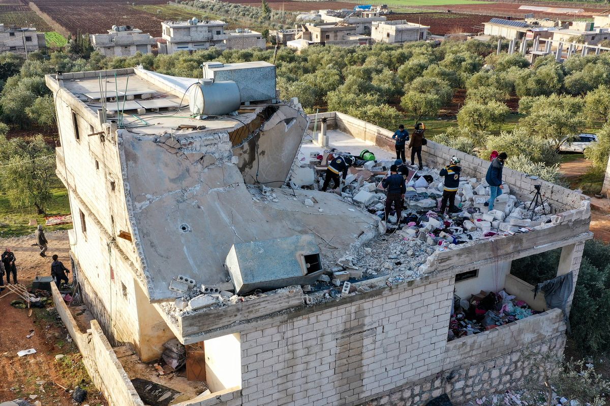 People inspect a destroyed house Thursday following an operation by the U.S. military in the Syrian village of Atmeh, in Idlib province. (Ghaith Alsayed)