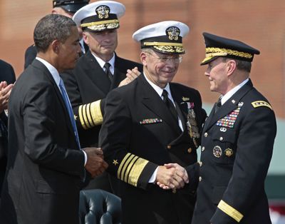 President Barack Obama watches as retiring Joint Chiefs Chairman Adm. Mike Mullen, center, shakes hand with incoming Joint Chiefs Chairman Gen. Martin Dempsey, during a  'Change of Office' Chairman of the Joint Chiefs of Staff ceremony at Ft. Myer in Arlington, Va., Friday, Sept., 30, 2011.  (AP/Pablo Martinez Monsivais)
