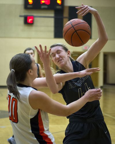 Mead’s Sue Winger, right, and Lewis and Clark’s Riley Lupfer go after a rebound in the first half of Tuesday night’s game. (Colin Mulvany)