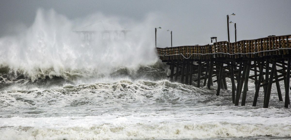 Waves slam the Oceana Pier & Pier House Restaurant in Atlantic Beach, N.C., Thursday, Sept. 13, 2018 as Hurricane Florence approaches the area. (Travis Long / AP)
