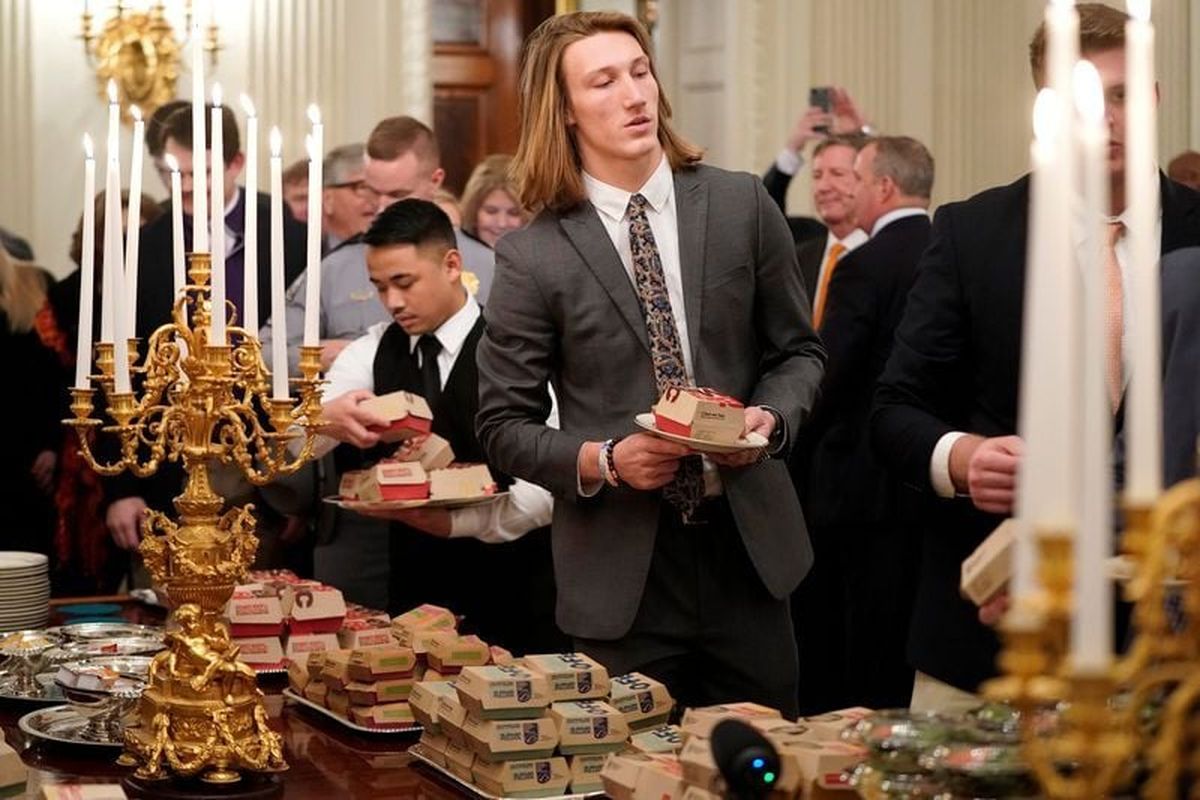 Trevor Lawrence carries fast food hamburgers in the State Dining Room of the White House in Washington on Jan. 14, 2019.  (Joshua Roberts, Reuters)
