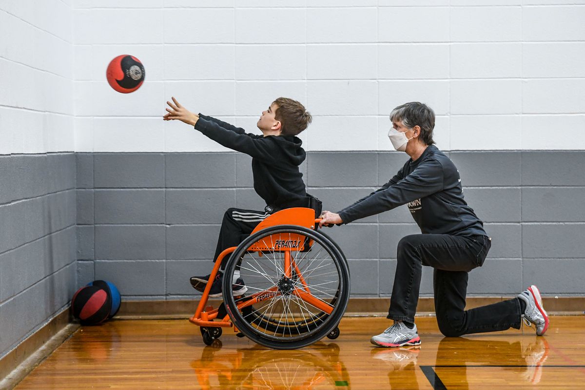 Jack Coy, 11, born with mild cerebral palsy, works with coach volunteer Shirley Carlson during a ParaSport strength and conditioning session Feb. 8 at Valley Christian High School in Spokane.  (Dan Pelle/The Spokesman-Review)