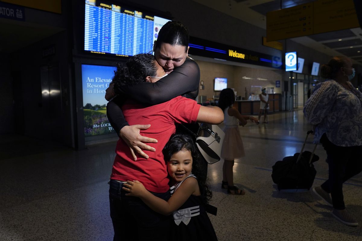 Emely, left, is reunited with her mother, Glenda Valdez and sister, Zuri, at Austin-Bergstrom International Airport, Sunday, June 6, 2021, in Austin, Texas. It had been six years since Valdez said goodbye to her daughter Emely in Honduras. Then, last month, she caught a glimpse of a televised Associated Press photo of a little girl in a red hoodie and knew that Emely had made the trip alone into the United States. On Sunday, the child was returned to her mother’s custody.  (Eric Gay)