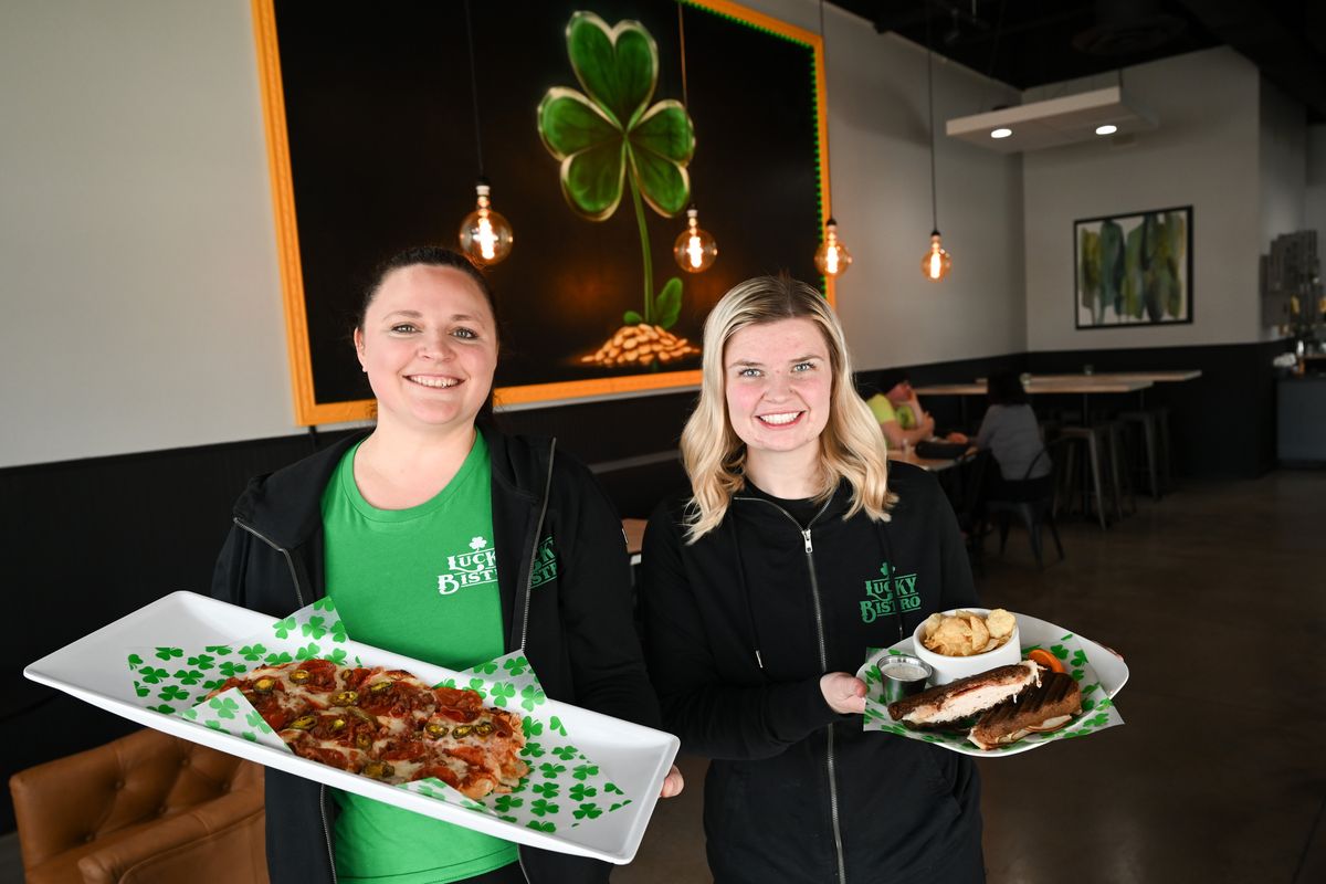 Lucky Bistro manager Jaclyn Salvador, left, holds a flatbread while assistant manager Jaelyn McKinney holds a turkey bacon panini, as they pose for a photo on April 11 at Lucky Bistro, 325 S. Sullivan Road in Veradale. (Tyler Tjomsland/The Spokesman-Review)