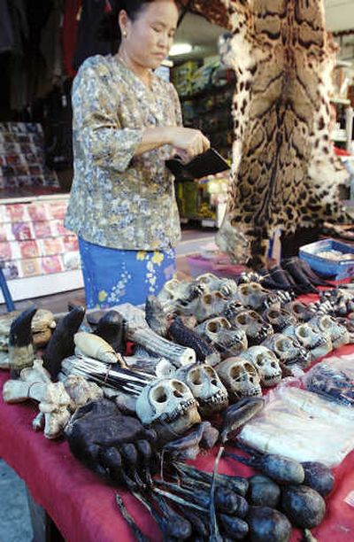 
A Myanmar vendor  sells endangered animal bones and skins  in  2003. Almost a third of all apes, monkeys and other primates are in danger of extinction, according to a report released today. Associated Press
 (File Associated Press / The Spokesman-Review)
