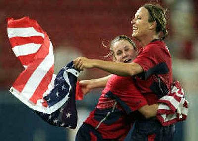 
 Abby Wambach, right, and Heather O'Reilly of the Team USA women's soccer team celebrate after beating Brazil in the gold medal match Thursday in Athens. Wambach's goal in extra time gave the U.S. a 2-1 victory.
 (Reuters / The Spokesman-Review)