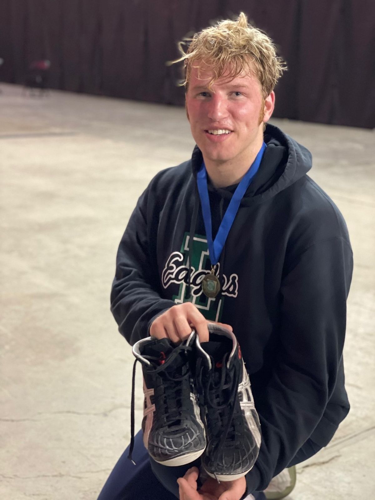 Kimball Rippy poses with the borrowed shoes he used to win the Class 1A state title at 220 on Feb. 19, 2022 at Tacoma Dome.  (Courtesy)