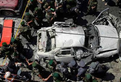
Lebanese army officers surround the destroyed car of slain Lebanese journalist Samir Kassir following an explosion in Beirut on Thursday. Kassir, known for his anti-Syrian writings, was killed after a bomb placed in his car exploded, police said. 
 (Associated Press / The Spokesman-Review)
