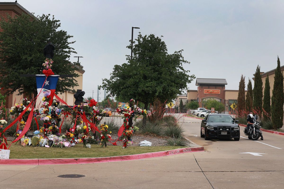 Police block an entrance near a memorial to those killed at the Allen Premium Outlets mall after the mass shooting occurred on Monday, in Allen, Texas. On May 6, a shooter opened fire at the outlet mall, killing eight people. The gunman was then killed by an Allen Police officer responding to an unrelated call.  (Joe Raedle/Getty Images North America/TNS)
