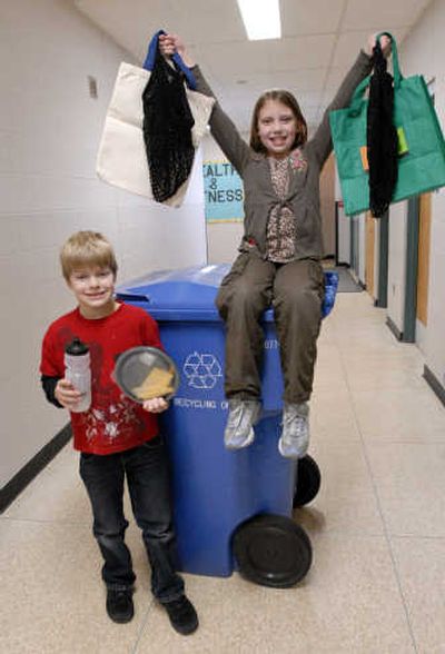 
Skyview third-graders Devin Sabie and Makayla Sotin show reusable containers and bags that they have been learning about from their teacher, Karin Steever (pictured on the cover), and conservation as it reflects on the planet Earth. 
 (J. BART RAYNIAK / The Spokesman-Review)