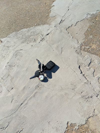 This botched concrete repair might be traced to poor eyesight, poor skills or an I-don’t-care attitude. The truck keys, fob and Mike Mulligan charm are for scale.  (Tribune Content Agency)