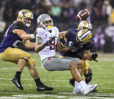 WSU WR Isaiah Johnson-Mack (9) is blasted by Washington DB Byron Murphy on a pass attempt at during the Apple Cup in Husky Stadium, Saturday, Nov. 25, 2017, in Seattle, Wash. (Dan Pelle / The Spokesman-Review)