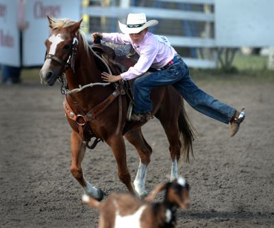 Getting his goat: Caden Marker, 9, swings off his horse with his eye on his target during the goat flanking event at the Cheney Peewee Rodeo on Sunday. In goat flanking, contestants approach on their horse, dismount, and throw the goat on its side, but don’t actually tie the legs. See more at spokesman.com/picture-stories. (Jesse Tinsley)