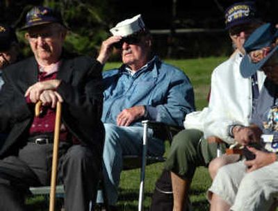 
Thor Olson, center, shades his eyes while listening to the opening ceremony at the annual Farragut reunion. Olson was 29 when he went through Navy training at Farragut in 1944. 
 (JESSE TINSLEY Photos / The Spokesman-Review)