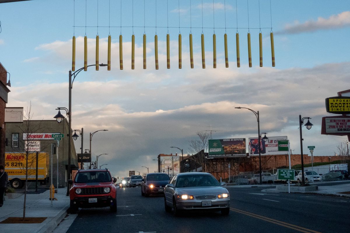 A string of plastic tubes hanging above East Sprague are designed to tap the roofs of tall trucks to warn the driver that they are approaching a low bridge where the train tracks cross Sprague Avenue and Division Street, shown Tuesday, Nov. 16, 2021. The railroad trestles that cars must pass under are 13-foot 8 inches above the roadway.  (Jesse Tinsley/The Spokesman-Review)