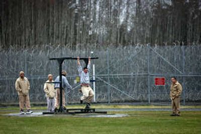 
Surrounded by high fences and razor wire, inmates exercise in the outside yard last month at Clallam Bay Corrections Center on the Olympic Peninsula. Associated Press photos
 (Associated Press photos / The Spokesman-Review)