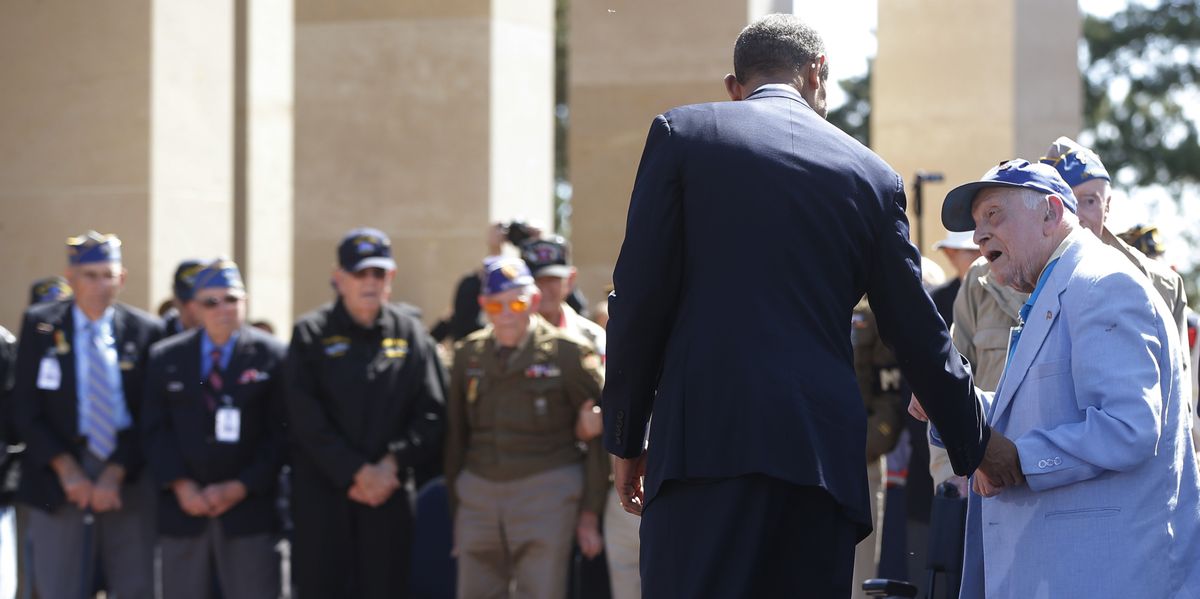 A veteran talks to President Barack Obama at the Normandy American Cemetery and Memorial above Omaha Beach as he participates Friday in ceremonies marking the 70th anniversary of D-Day in Colleville sur Mer, France. (Associated Press)