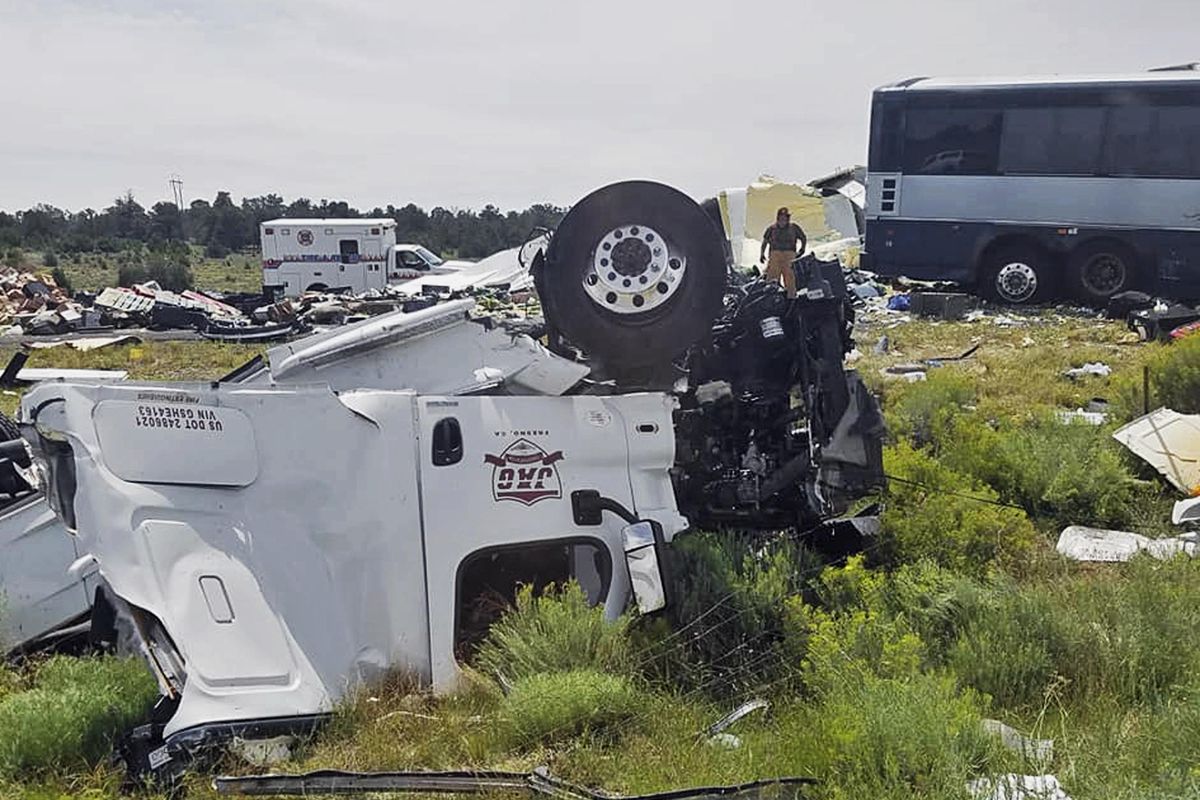First responders work the scene of a collision between a Greyhound passenger bus and a semi-truck on Interstate 40 near the town of Thoreau, N.M., near the Arizona border, Thursday, Aug. 30, 2018. Authorities say the a blown tire on the semi-truck may have caused the semi to cross a median and crash into a Greyhound bus. (Chris Jones / Associated Press)