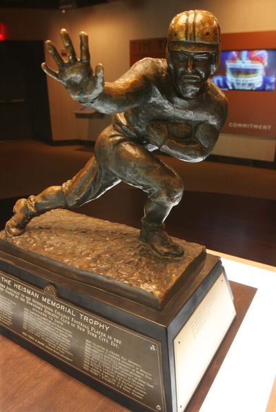 Fans at Saturday’s Whitworth game will get a chance to pose with the Heisman Trophy. (Associated Press)
