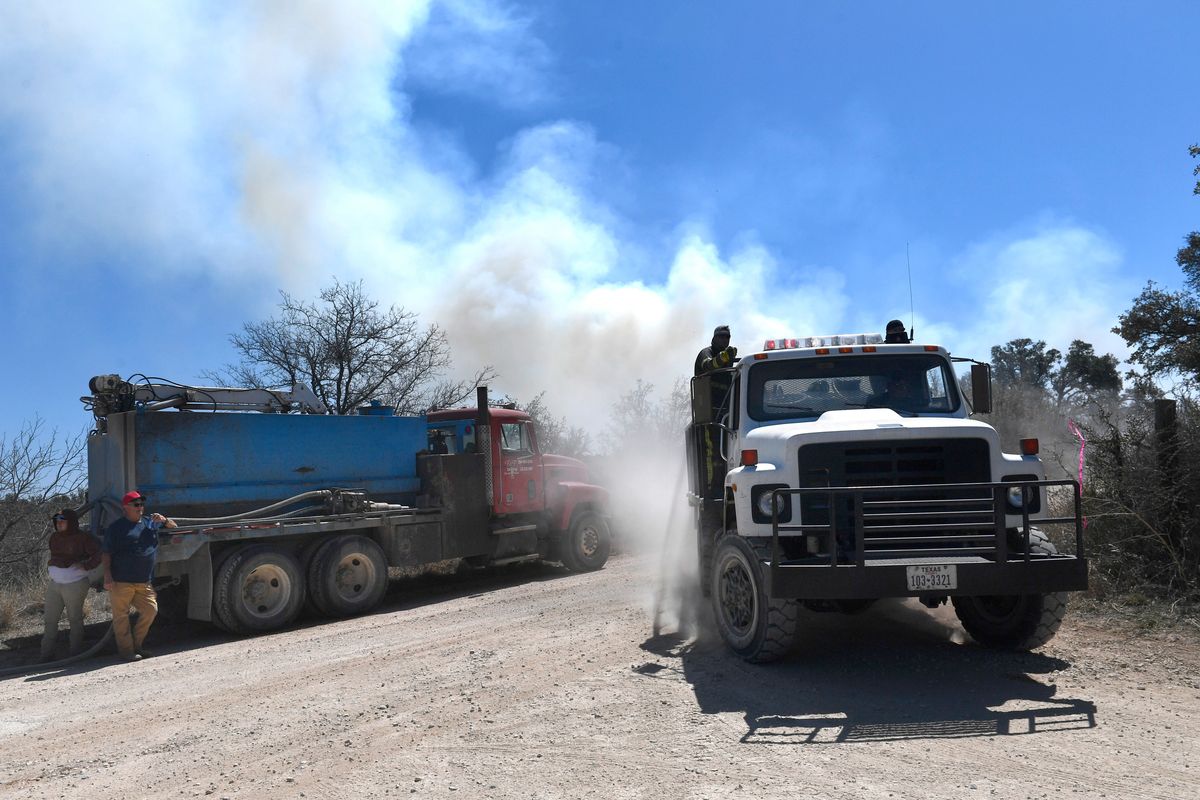 Members of the Carbon Volunteer Fire Department pass through a rural Eastland County, Texas, intersection Saturday while fighting the Kidd Fire. (Ronald W. Erdrich)