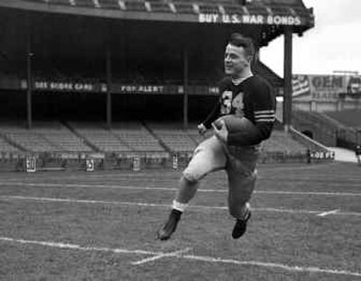 
Army back Glenn Davis, carrying the ball in this 1944 file photo, won the Heisman Trophy in 1946 and helped lead Army to three national championships. He died Wednesday. 
 (Associated Press / The Spokesman-Review)
