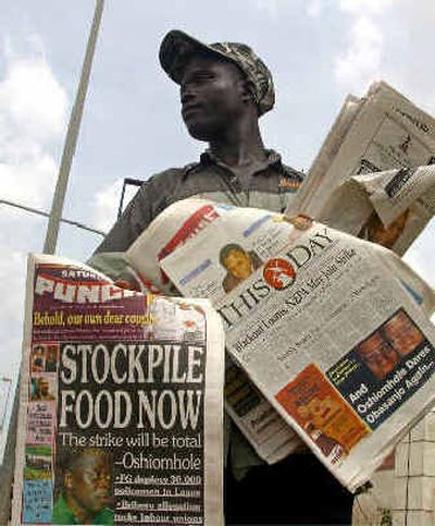 
An unidentified street vendor sells copies of local Nigerian newspapers.
 (Associated Press / The Spokesman-Review)