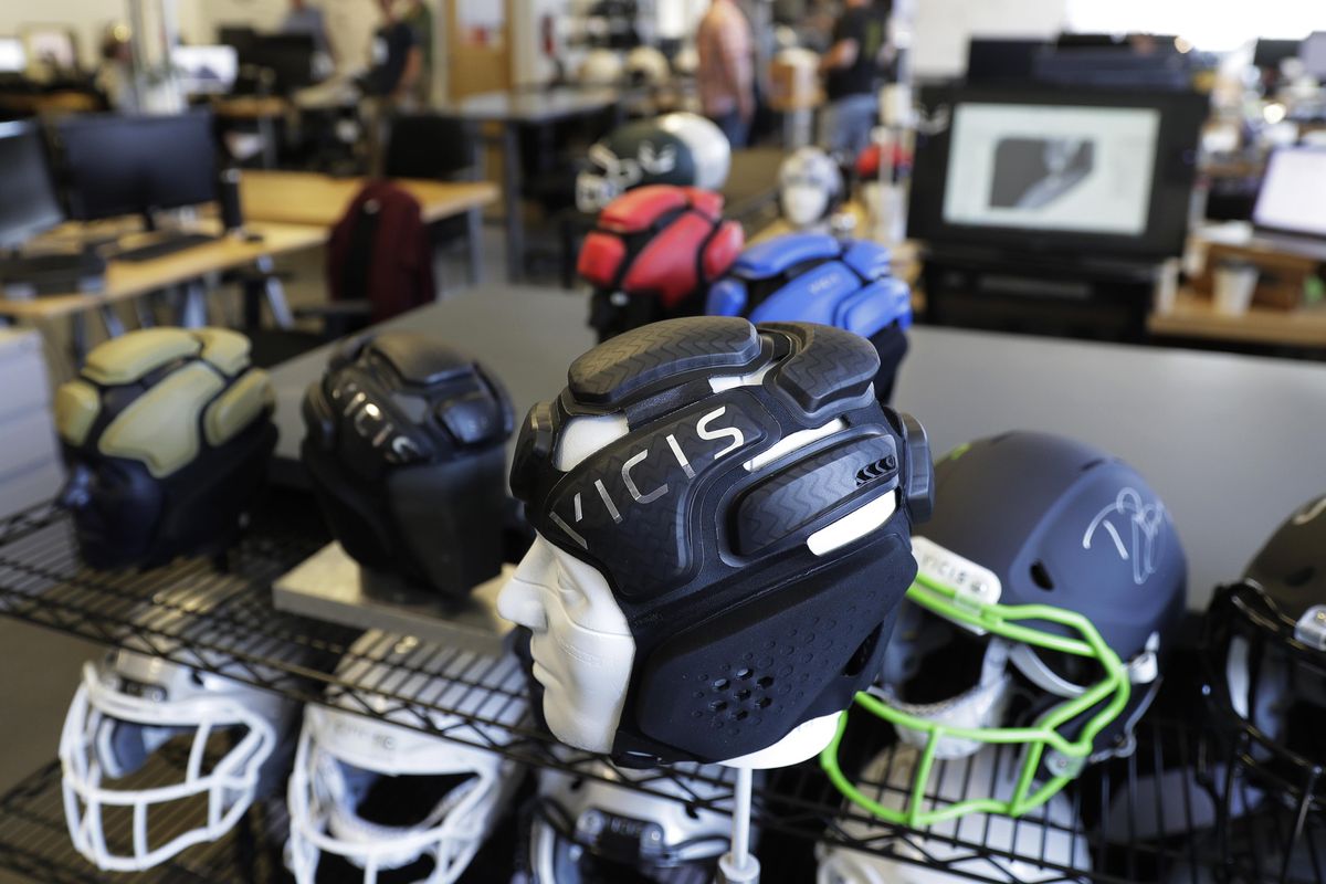 Helmets are seen on a rack at the Seattle headquarters of football helmet maker VICIS. The company