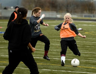 University High School’s Shayla Weiler, right, worked on  her scoring technique prior to a playoff game in Kennewick against Kamiakin Nov. 10. The Titans lost during the second overtime period. (Colin Mulvany)