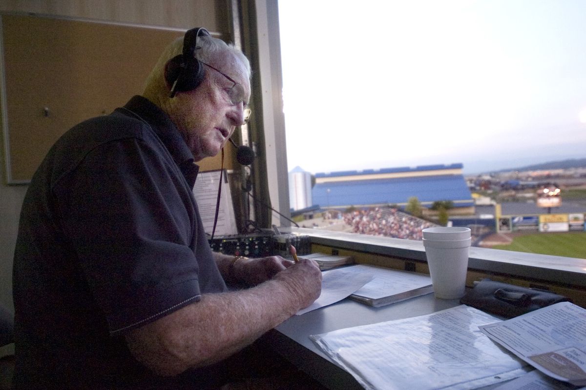 In this Sept. 3, 2006 photo, the radio voice of the Spokane Indians, Bob Robertson, organizes some statistics between innings. Robertson has been calling Indians games since the 1999 season.  (The Spokesman-Review photo archive)
