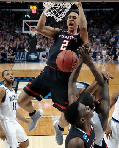 In this March 25, 2018, file photo, Texas Tech’s Zhaire Smith, top, dunks against Villanova during the second half of an NCAA men’s college basketball tournament regional final in Boston. Texas Tech standout freshman guard Smith says he is signing with an agent and will be available in the NBA draft. Smith said in a Twitter post that he is signing with Roc Nation and forgoing the rest of his collegiate career. (Charles Krupa / Associated Press)