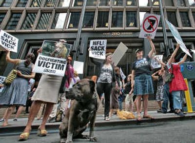 
PETA protesters carry signs and shout slogans calling for suspension of Falcons QB Michael Vick. Associated Press
 (Associated Press / The Spokesman-Review)