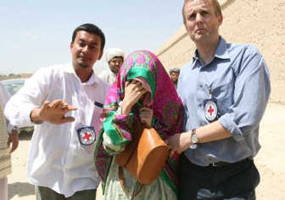 
A South Korean is escorted by Red Cross workers after being released by the Taliban on Wednesday. Associated Press
 (Associated Press / The Spokesman-Review)