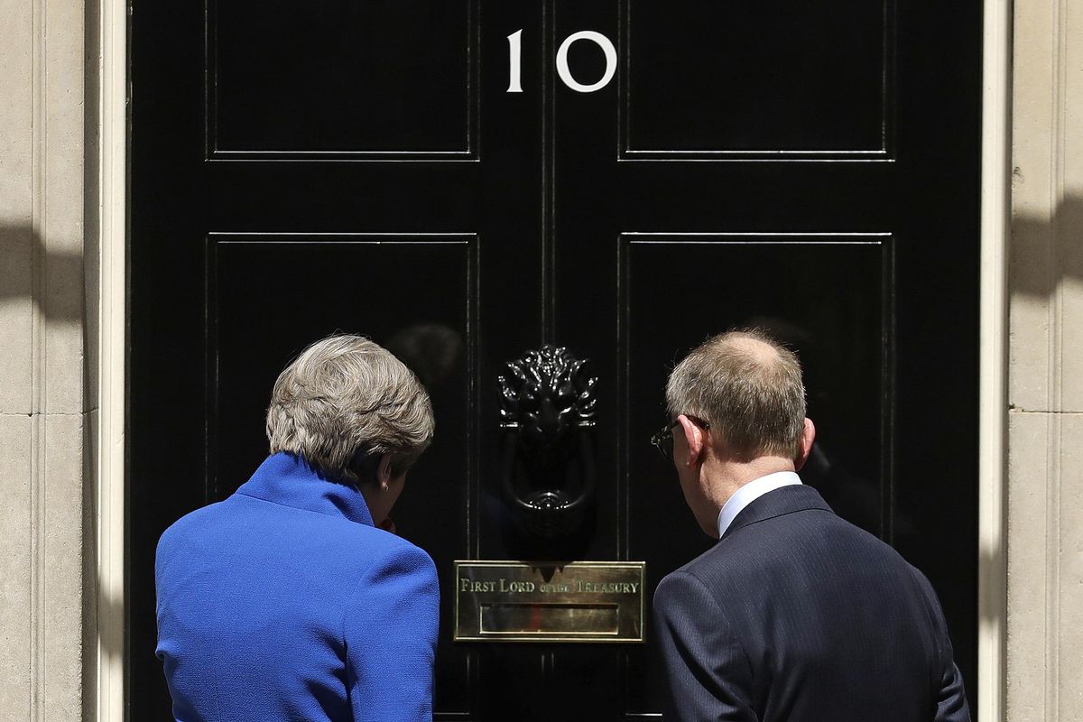 British Prime Minister Theresa May and her husband Philip stand on the doorstep of 10 Downing street, London, after addressing the press Friday, June 9, 2017 following an audience with Britain's Queen Elizabeth II at Buckingham Palace where she asked to form a government. May's gamble in calling an early election backfired spectacularly, as her Conservative Party lost its majority in Parliament. (Matt Dunham / Associated Press)