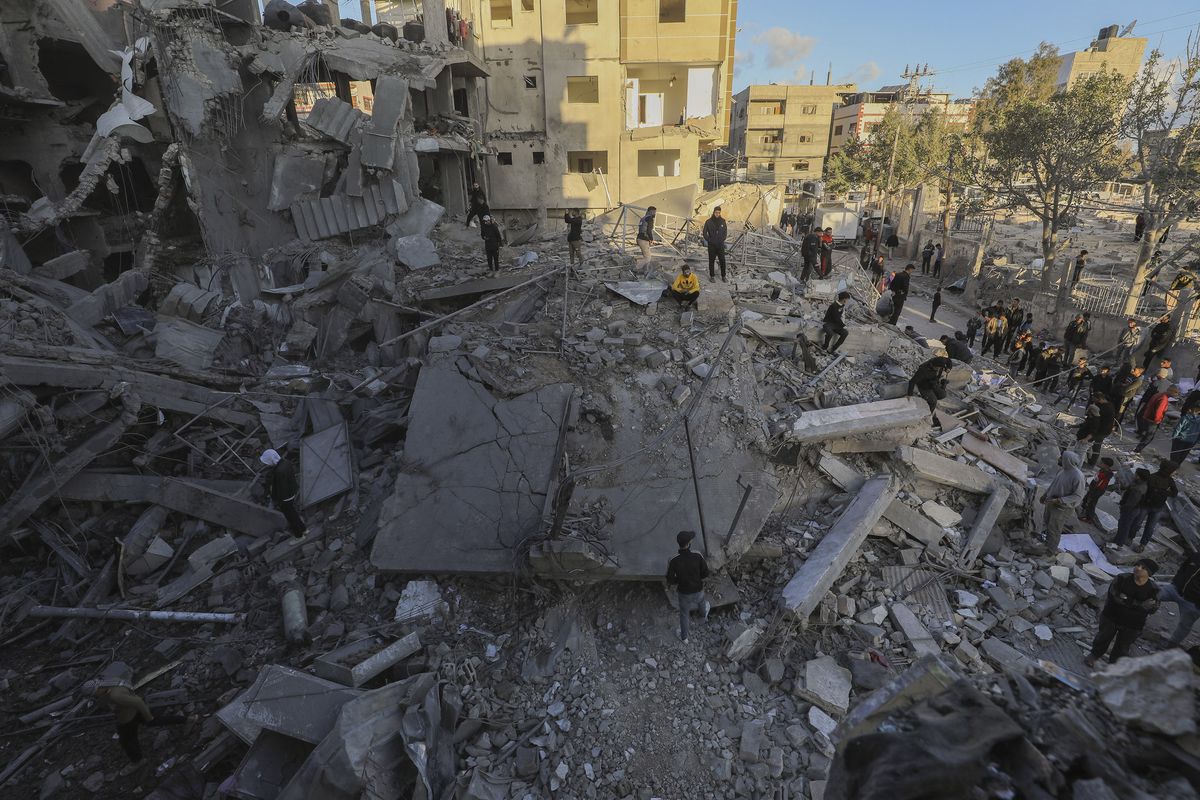 Palestinians inspect damage at the site of an Israeli strike on a house amid the Israel-Hamas conflict at the Nuseirat refugee camp in the central Gaza Strip on Dec. 13, 2024.  (Moiz Salhi/Middle East Images via AFP/Getty Images/TNS)