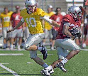 WSU freshman quarterback Jeff Tuel, handing off to freshman running back Arthur Burns during practice in August, is now playing for real. (CHRISTOPHER ANDERSON / The Spokesman-Review)
