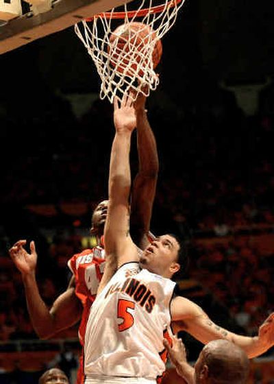 
Illinois guard Deron Williams battles Wisconsin's Alando Tucker for a rebound in a Big Ten showdown on Saturday.
 (Associated Press / The Spokesman-Review)