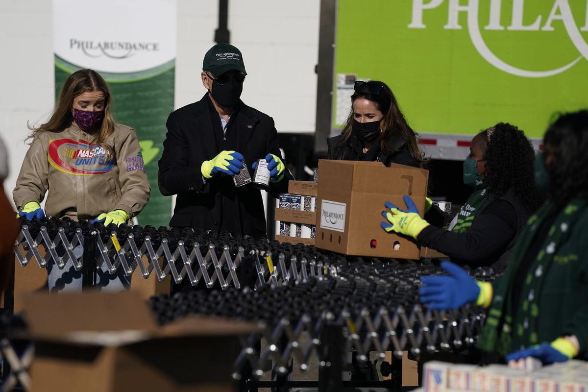 President-elect Joe Biden participates in a National Day of Service event at Philabundance, a hunger relief organization, with his daughter Ashley Biden, and his granddaughter Finnegan Biden, left, Monday, Jan. 18, 2021, in Philadelphia. (Evan Vucci)