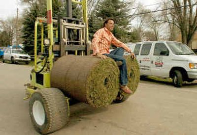 
Designer Michael Moloney rides on sod destined for an 