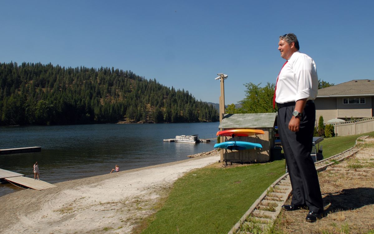 Jeff Smith, organizer for the Rathdrum Mountain Adventure Race, looks down to the beach at Twin Lakes Village Tuesday. The beach is where the kayak portion of the race will end and the run begin. The race, designed to feature the beauty of the area, will be Sept. 6 and will be a combination of biking, kayaking and running. (Jesse Tinsley / The Spokesman-Review)