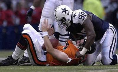 
Bears quarterback Jonathan Quinn, bottom, calls for a timeout after he was sacked by Cowboys defensive end Greg Ellis. 
 (Associated Press / The Spokesman-Review)
