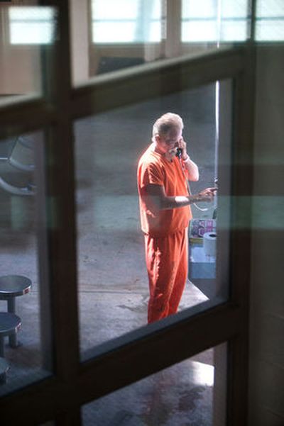 A Kootenai County Jail inmate places a call on Tuesday in Coeur d’Alene. In internal audit by the county determined that inmates and their families weren’t properly informed of expense service charges. (Kristen McPeek / Coeur d'Alene Press)