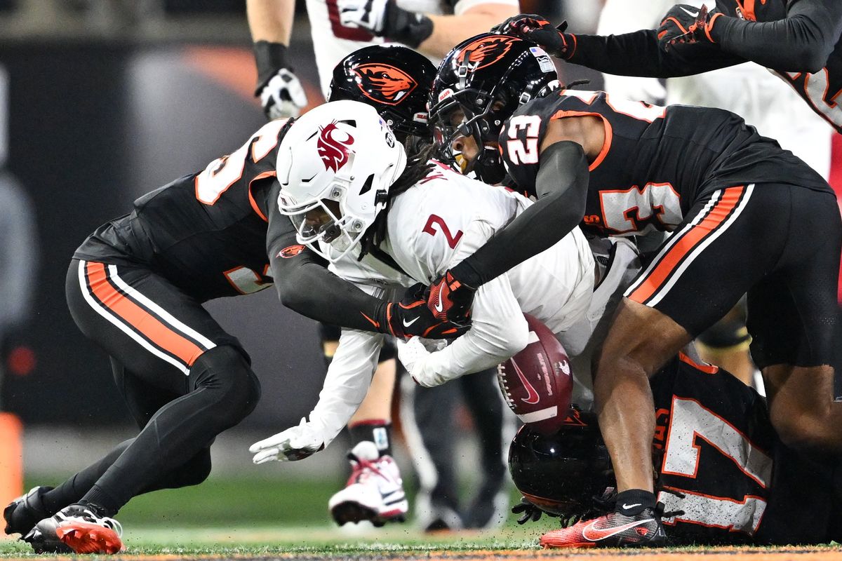 Oregon State Beavers linebacker Dexter Foster (55) and defensive back Exodus Ayers (23) force a fumble by Washington State Cougars wide receiver Kyle Williams (2) to get possession of the ball in the final moments of the second half of a college football game on Saturday, Nov. 23, 2024, at Reser Stadium in Corvallis, Ore. Oregon State won the game 41-38. 