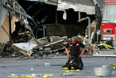 
A firefighter takes a moment after helping put out the fire that  killed nine  firefighters at a furniture store Tuesday  in Charleston, S.C.Associated Press
 (Associated Press / The Spokesman-Review)