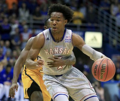 Toledo guard Marreon Jackson, back, hangs on to Kansas guard Devonte' Graham (4) during the first half of an NCAA college basketball game in Lawrence, Kan., Tuesday, Nov. 28, 2017. There was no foul on the play. (AP Photo/Orlin Wagner) ORG XMIT: KSOW103 (Orlin Wagner / AP)