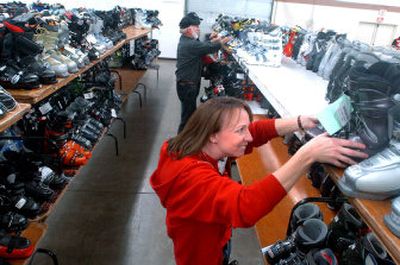 Vickie Brooks arranges boots Friday in preparation for today's Winter Swap ski sale at the Kootenai County Fairgrounds. The annual sale of used and new gear runs from 9 a.m. to 3 p.m.  in the exhibition buildings at the fairgrounds, with some of the proceeds going to the Silver Mountain and Lookout Pass ski patrols. 
 (Jesse Tinsley / The Spokesman-Review)